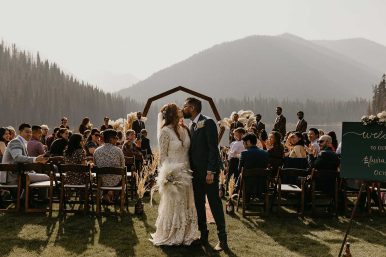 Manning Park Resort Couple just married in front of lake with guests at Manning park.